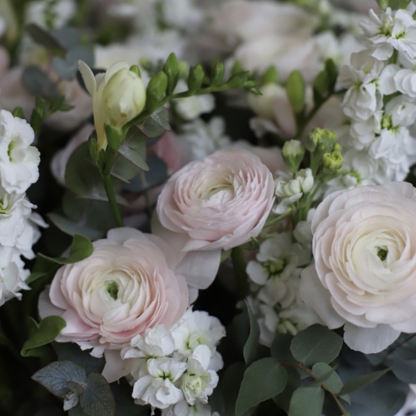 Ranunculuses with Freesia and Stock in a basket